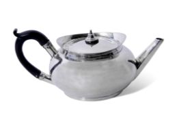 George III tea pot of compressed circular form with raised apron, angular spout, ebonised handle,