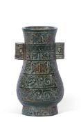 Chinese vase of archaic form with scroll decoration on a green, probably quartz, ground, 24cm high