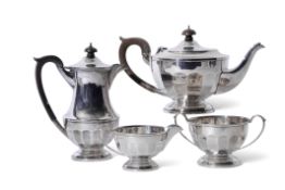 George V silver tea set of panelled circular form comprising tea pot, hot water jug, two handled