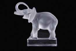 Lalique frosted glass elephant standing on rectangular base with trunk raised, 15cm tall