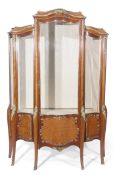 20th century mahogany Kingwood and gilt metal mounted serpentine fronted vitrine, with four fitted