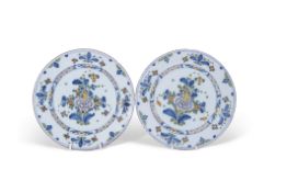 Pair of mid-18th century English Delft plates with polychrome design of flowers, probably Lambeth,