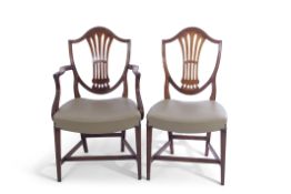 Set of fourteen Hepplewhite style mahogany pierced shield back dining chairs, 12 singles and two