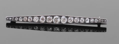 Diamond set brooch of elongated form featuring 21 graduated old cut diamonds, each individually claw