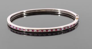 Diamond and ruby hinged bracelet, the top section with alternate small brilliant cut diamonds and