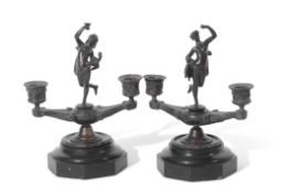 Pair of 19th century bronze two-light candelabra, each set with a central classical figure, raised