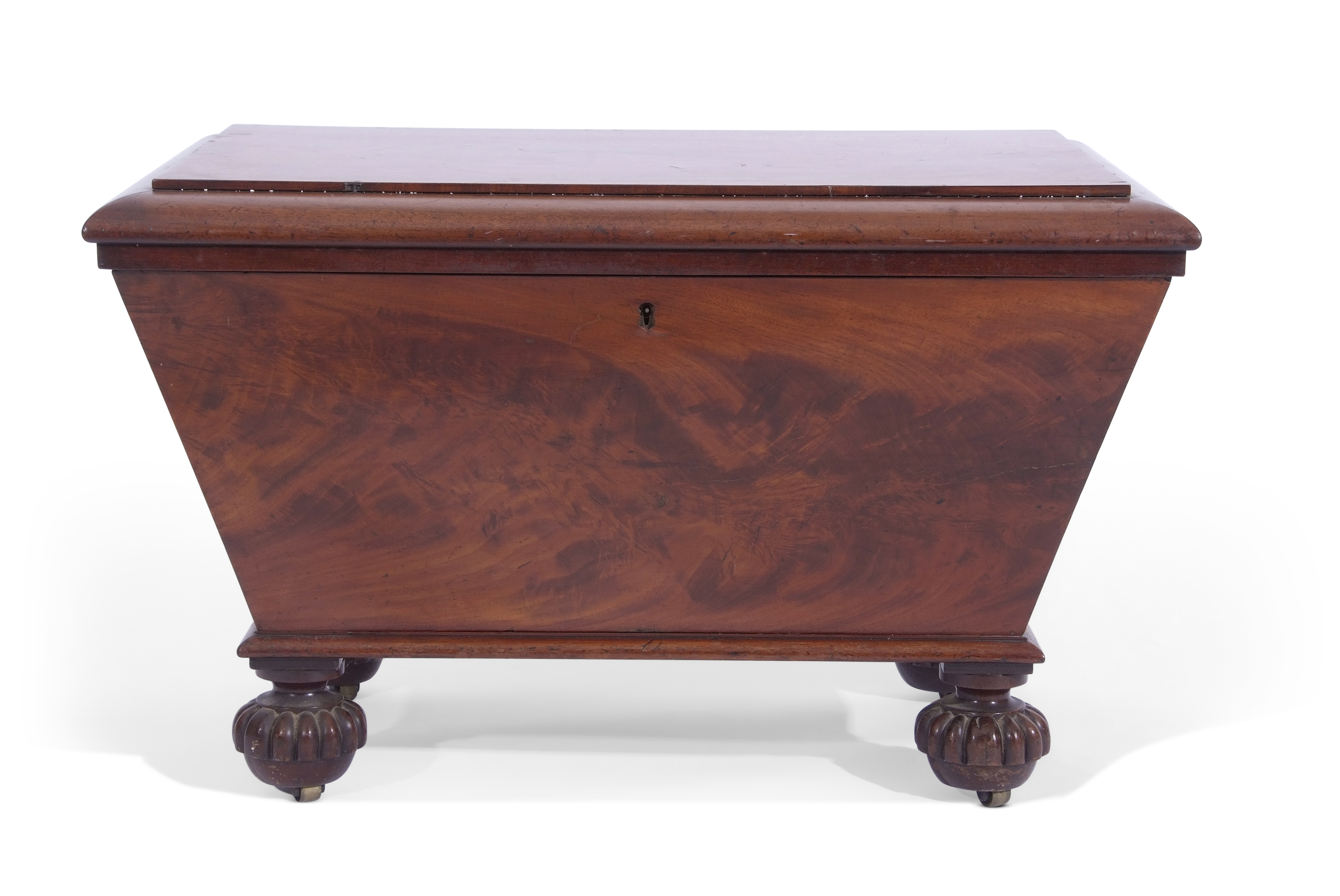 William IV mahogany wine cooler of sarcophagus form, supported on four fluted disc feet and