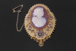 Victorian gold brooch/pendant of shaped oval form with a hardstone cameo mount within a