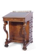 Victorian walnut Davenport with galleried top, the fall has a green leather insert with tooled edge,