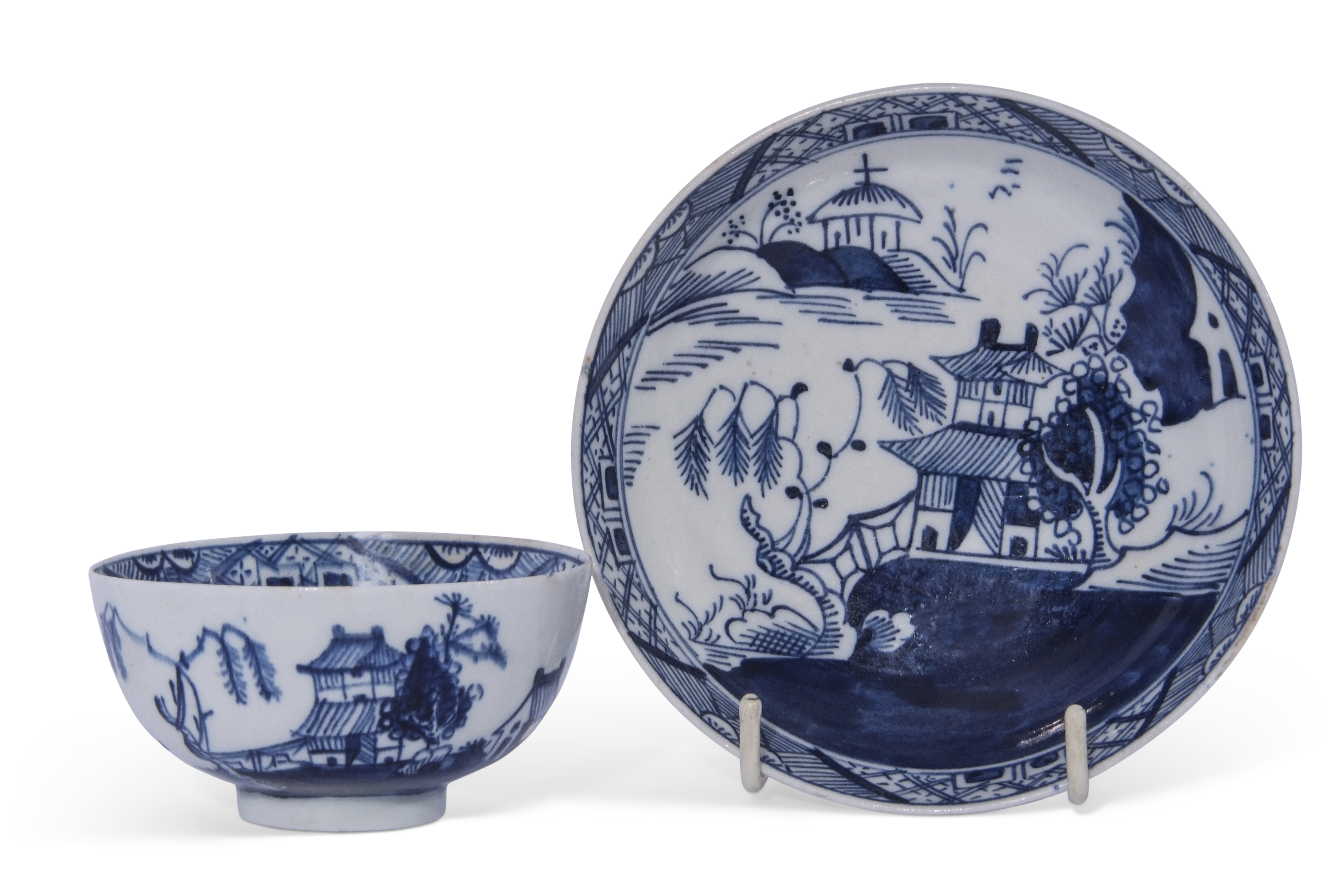 Lowestoft porcelain tea bowl and saucer decorated in underglaze blue with pagodas and flowering