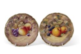 Two small Royal Worcester plates painted with fruit within shaped gilt rims, black factory mark to