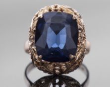 Large blue spinel dress ring, 14mm x 12mm, in a pierced carved and engraved mount, stamped 750, size