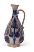 Large T Smith & Co pear-shaped jug, the buff body decorated with blue foliage in Lambeth Doulton