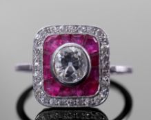 Diamond and calibre ruby target ring comprising a rub-over central old cut diamond, 0.70ct approx,