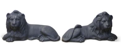 Pair of painted cast iron lions in recumbent pose, 80cm long x 41 cm tall x 31cm deep