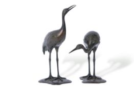 Pair of Japanese bronze cranes, Meiji period, standing on shaped bases, tallest 32cm high