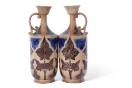 Good pair of J Smith & Co Art pottery jugs, the buff brown body with floral decoration in green,