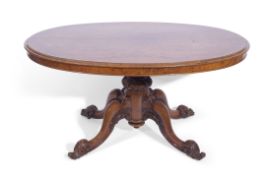 Victorian walnut oval loo table on turned and carved columns, supported on four carved cabriole