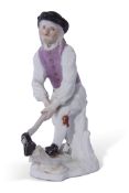 Meissen mid-18th century figure of a woodcutter after Kandler, Meissen crossed swords to rear,