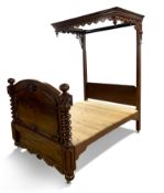 Victorian mahogany half tester bed circa 1850, with a half-canopy, a pierced cornice frieze of flame