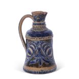 T Smith & Co Art pottery jug, the buff body decorated with incised foliage in blue, with similar