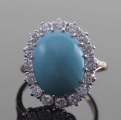 Turquoise and diamond cluster ring, the oval cabochon turquoise 15 x 10mm, within a surround of 16