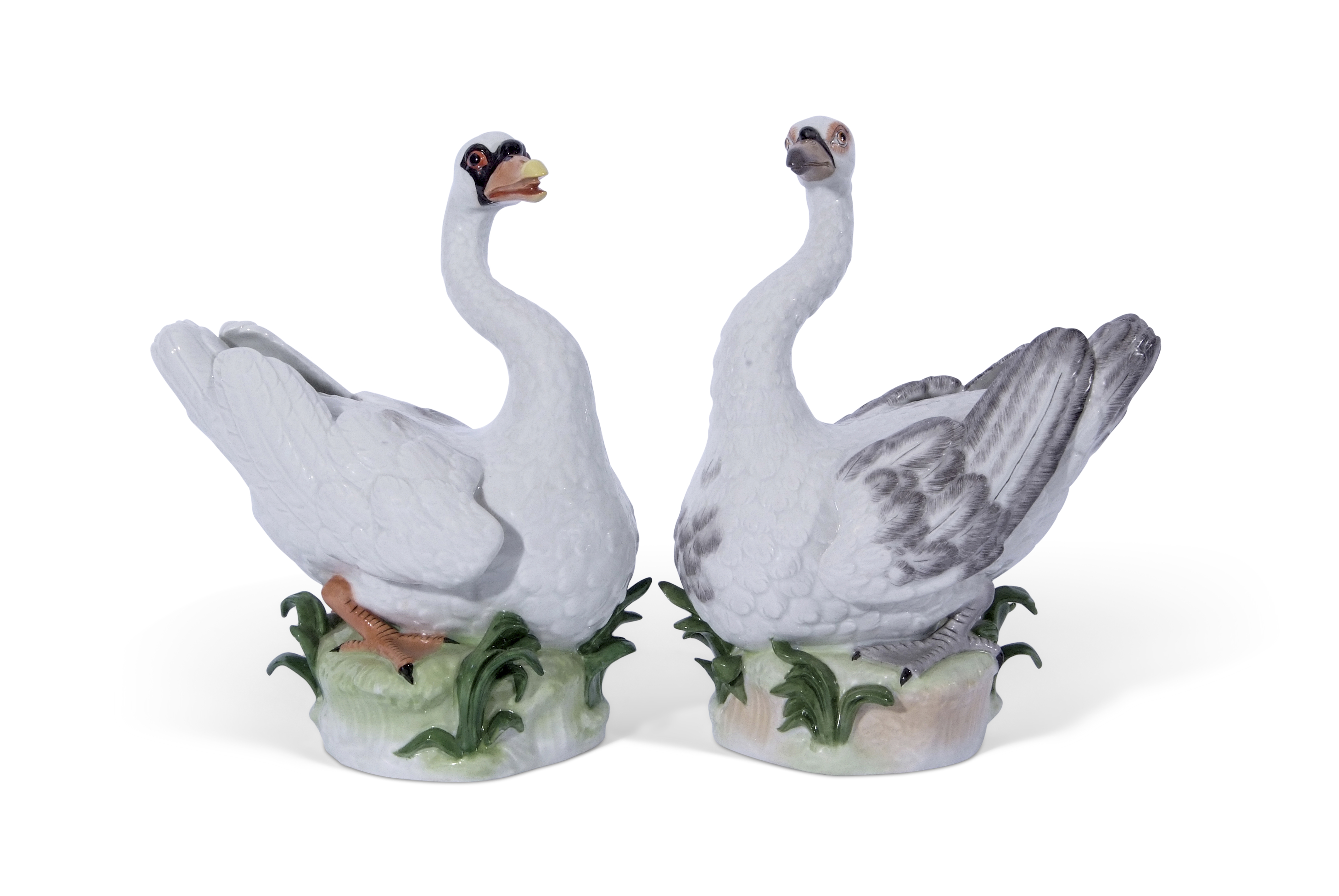 Large pair of Dresden porcelain swans on green leafy bases, modelled in Meissen style, 31cm high (