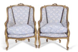 Pair of late 19th century French style carved giltwood armchairs, on front carved cabriole legs,