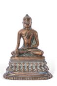 Gilt bronze model of a Buddha in typical pose, raised on shaped base, 15cm high