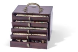 Chinese Mah Jong set in a hardwood case with metal mounts, the lift off front revealing five drawers