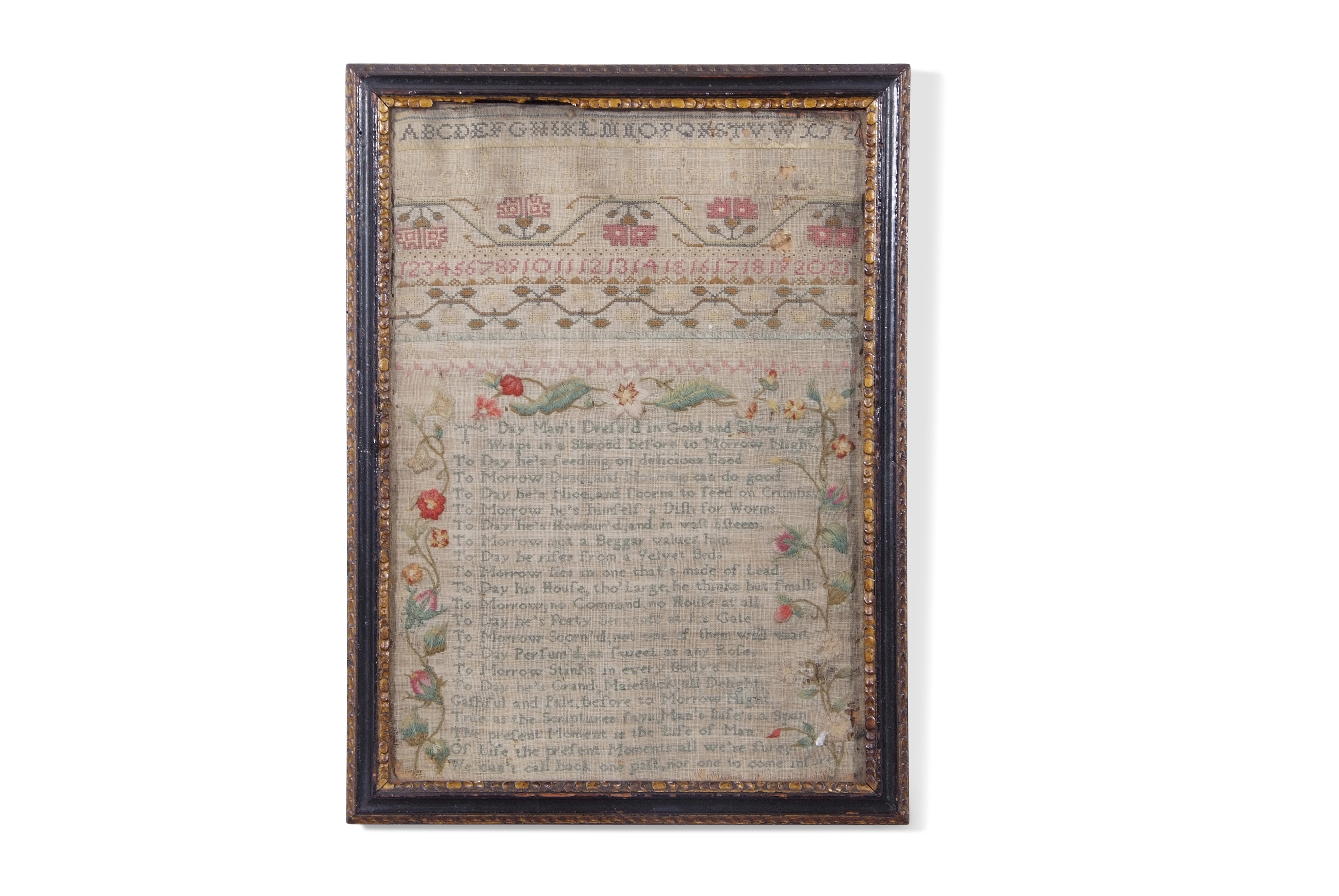 19th century needlework sampler decorated with rows of letters and numbers and an extensive text