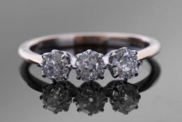 Diamond three stone ring featuring three round old brilliant cut diamonds, multi-claw set and raised