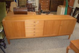 LARGE VINTAGE TEAK SIDEBOARD WITH THREE DOORS AND FIVE DRAWERS, BEARING LABEL TO INTERIOR "