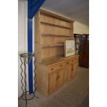 LARGE PINE DRESSER, THE SHELVED BACK OVER A BASE WITH THREE DRAWERS AND FOUR DOORS, 178CM WIDE
