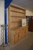 LARGE PINE DRESSER, THE SHELVED BACK OVER A BASE WITH THREE DRAWERS AND FOUR DOORS, 178CM WIDE