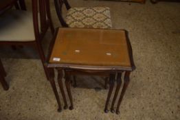 NEST OF THREE LEATHER AND GLASS TOPPED TABLES, LARGEST 53CM WIDE