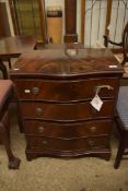 REPRODUCTION FLAME MAHOGANY VENEER SERPENTINE FRONT CHEST OF FOUR DRAWERS RAISED ON BRACKET FEET,