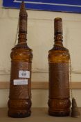 TWO LEATHER BOUND AMBER GLASS SPIRIT BOTTLES