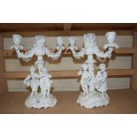 PAIR OF BLANC DE CHINE CANDELABRA DECORATED WITH FIGURAL BASES AND FLORAL DETAIL, 27CM HIGH