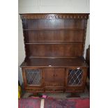 20TH CENTURY OAK DRESSER, THE SHELVED BACK WITH DRAWERS AND LEAD GLAZED DOORS, 126CM WIDE