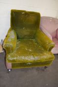 LARGE VICTORIAN DEEP SEATED ARMCHAIR, RAISED ON TURNED WOODEN LEGS AND CASTERS, SOLD FOR RE-