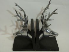 Pair of book ends both modelled with heads of stags in white metal