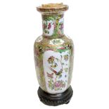 Chinese Cantonese porcelain vase mounted on wooden base decorated in famille rose style with