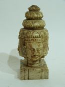 Oriental carved stone figure of heads of deities on square mount, (4)