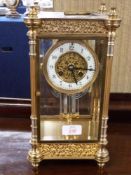 French gilt brass and four glass mounted clock, the circular white enamel face with Arabic