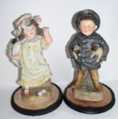 Pair of late 19th century Continental bisque figures of a boy and girl, possibly Russian, both