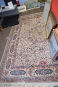 Wool carpet, beige coloured ground, blue and foliate pattern, gulled border, 12 x 9ft