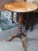 19th century mahogany tripod table with turned column raised on tripod base, 70cm high