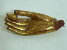 Oriental wooden study of a hand with red and gilt highlights, possibly from a religious figure