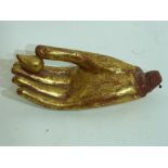 Oriental wooden study of a hand with red and gilt highlights, possibly from a religious figure